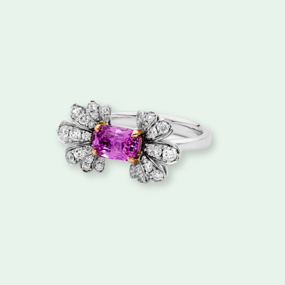 18k White gold ring with a pink sapphire and diamond accents.