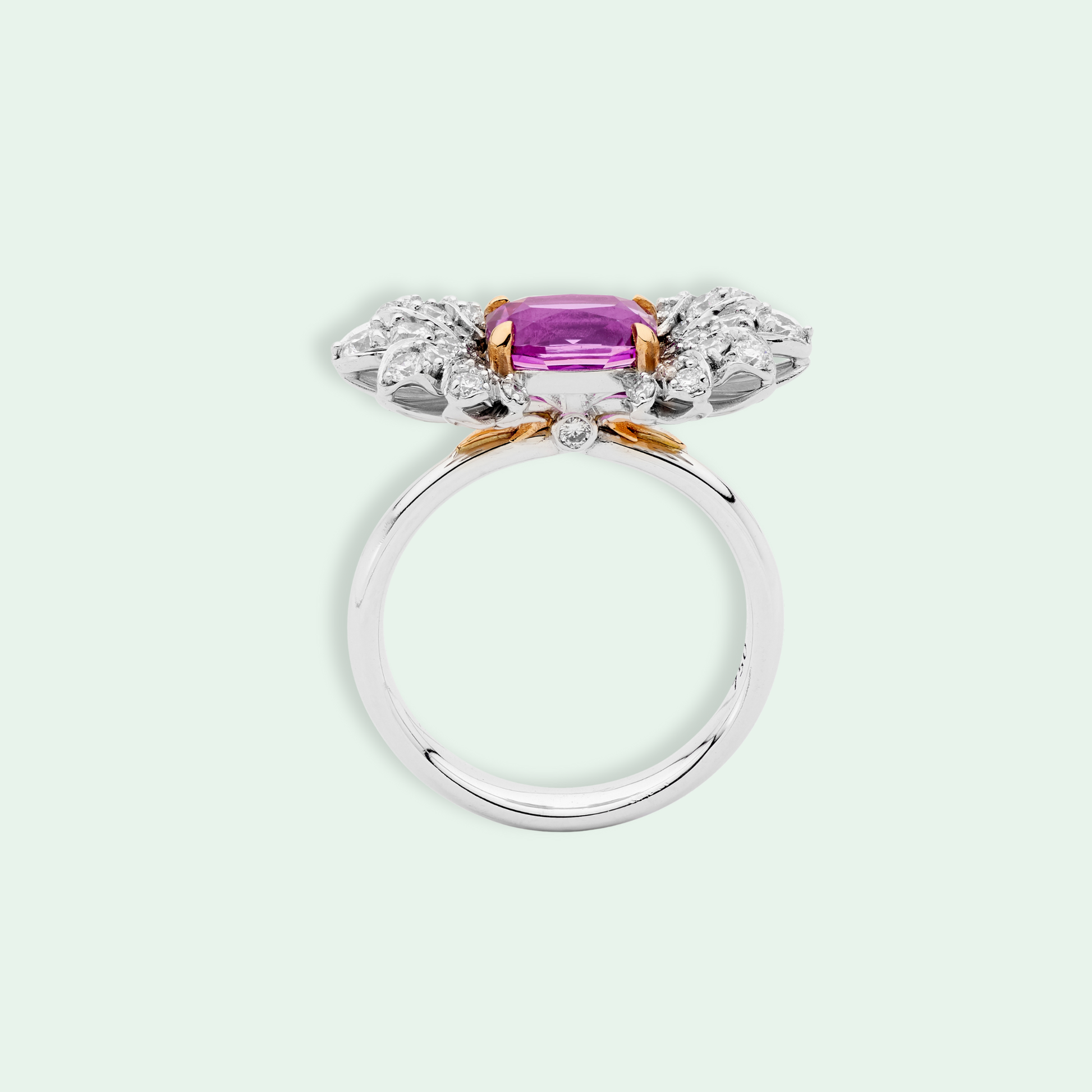 18k White gold ring with a pink sapphire and diamond accents.