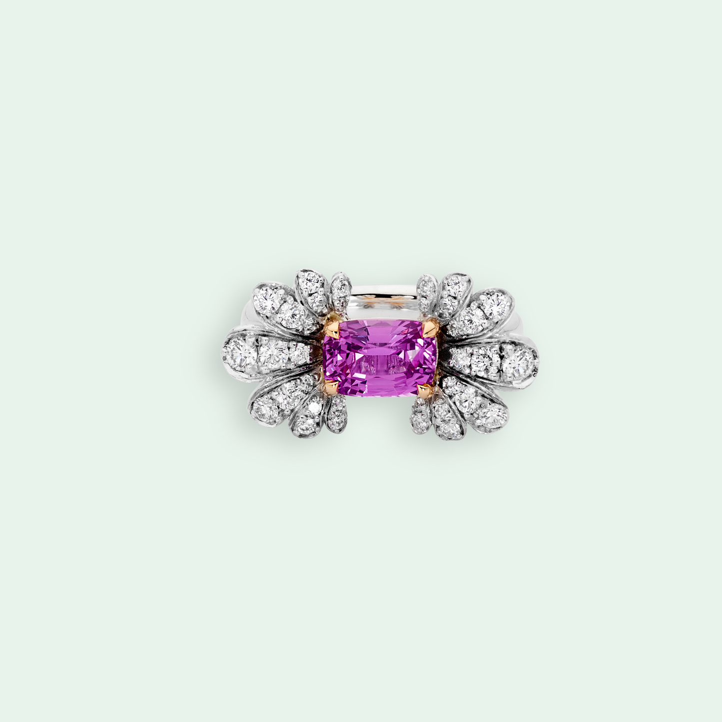 Diamond-encrusted ring with a pink gemstone on a light gray background
